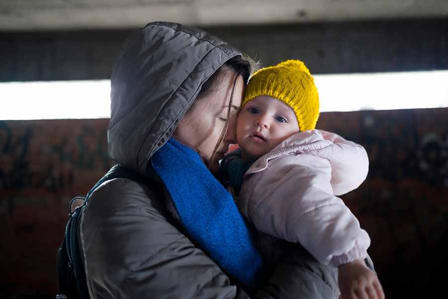 Loving mother holding her child in the bomb shelter